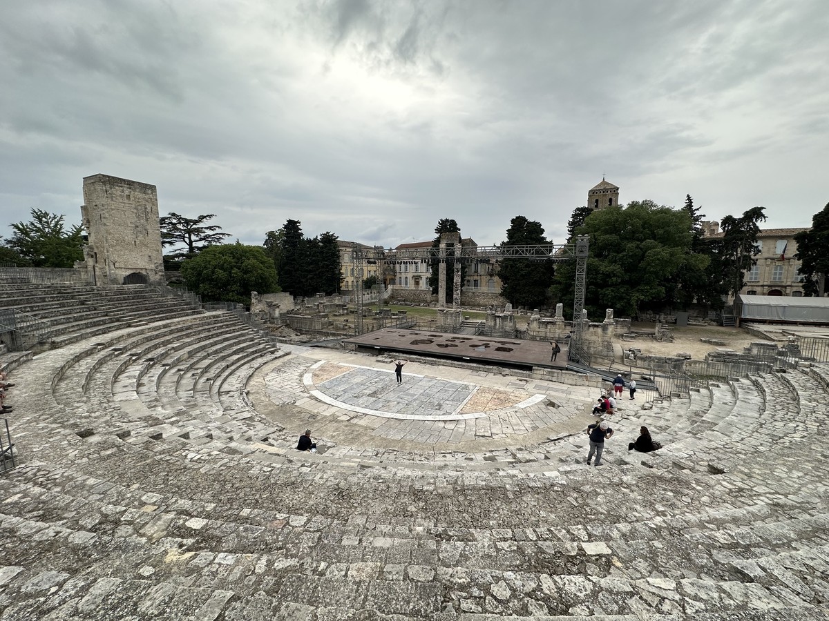 Ruins of the Roman Theater in Arles with remaining columns and semicircular stone seating