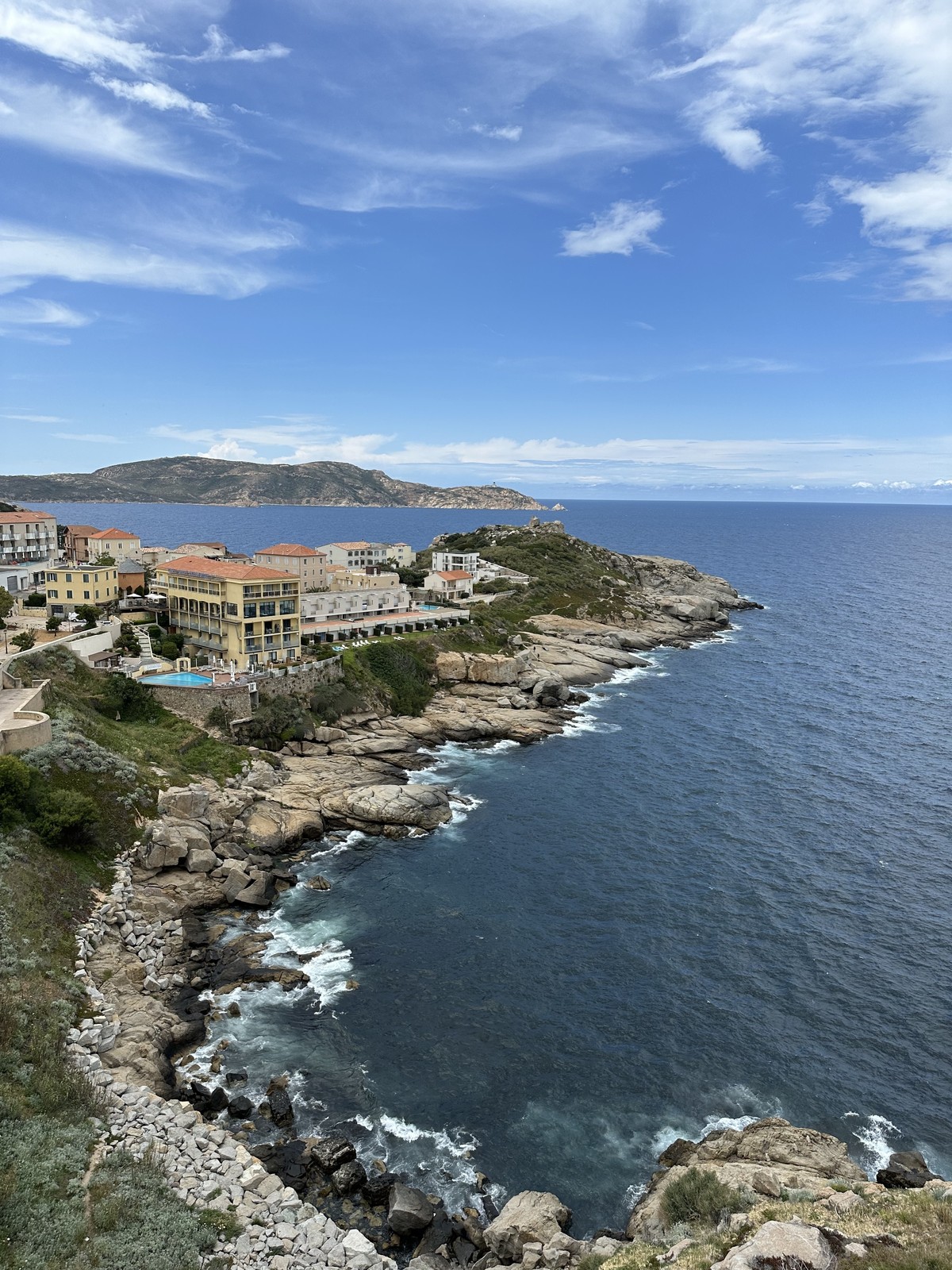 Rugged Corsican coastline with limestone cliffs and turquoise Mediterranean water