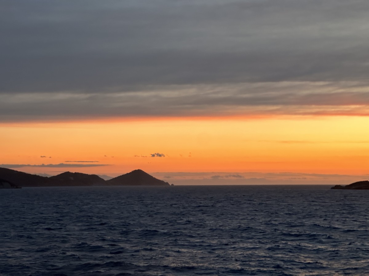 Golden sunset over the Mediterranean Sea viewed from the cruise ship deck leaving Elba