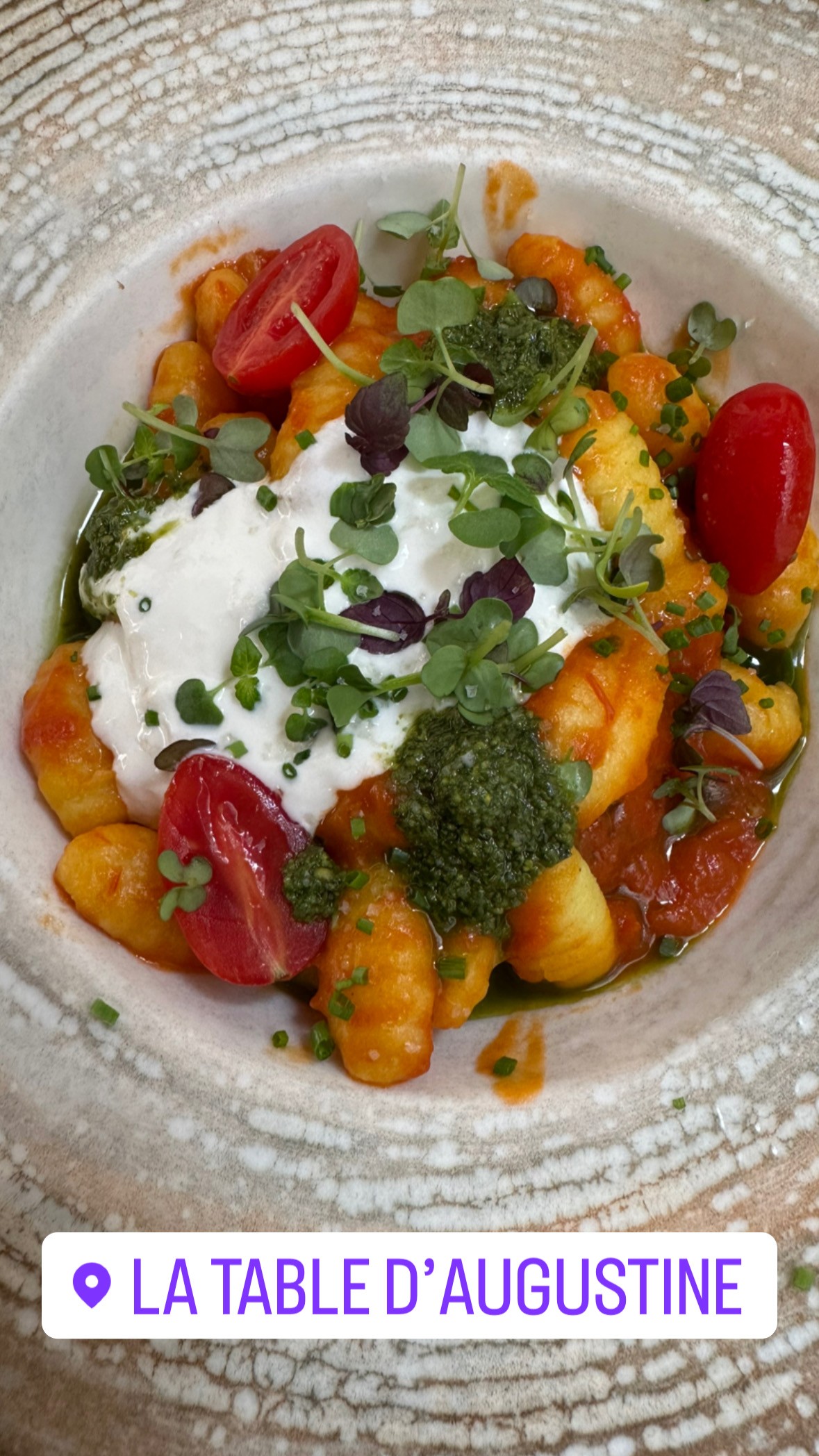 Bowl of gnocchi with burrata, pesto, and cherry tomatoes at La Table d’Augustine in Marseille