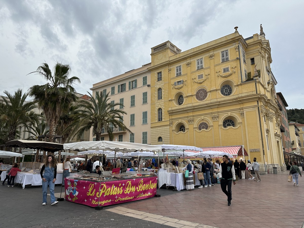 Flower and produce market on Cours Saleya in Nice with colorful stalls under awnings