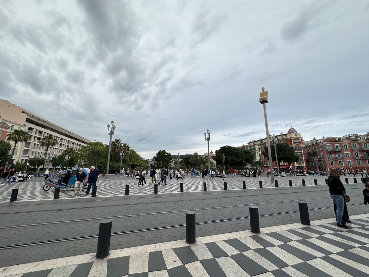 Place Masséna in Nice with its red buildings, checkerboard pavement, and modern art sculptures