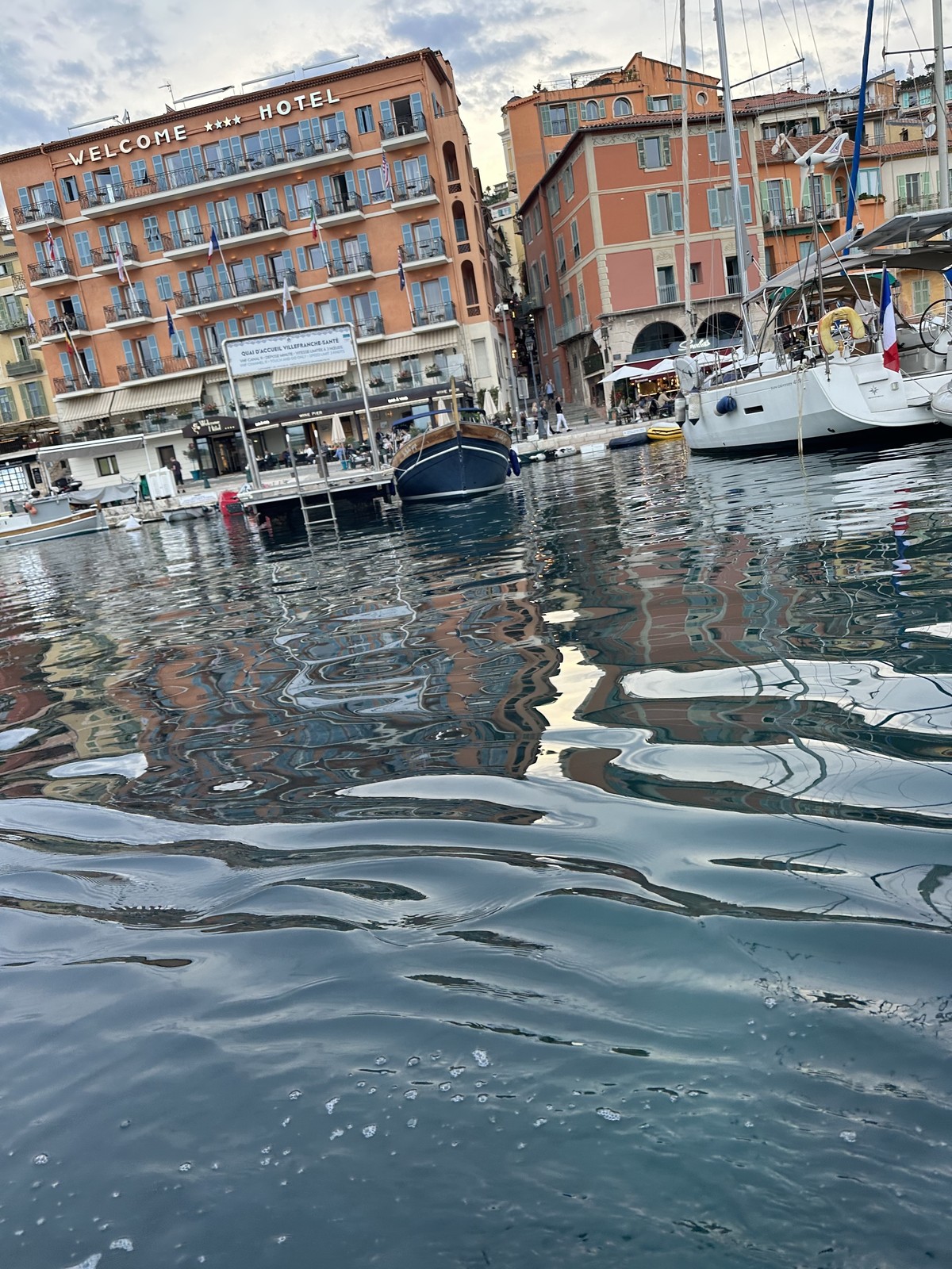 Villefranche-sur-Mer harbor at dusk with warm golden light