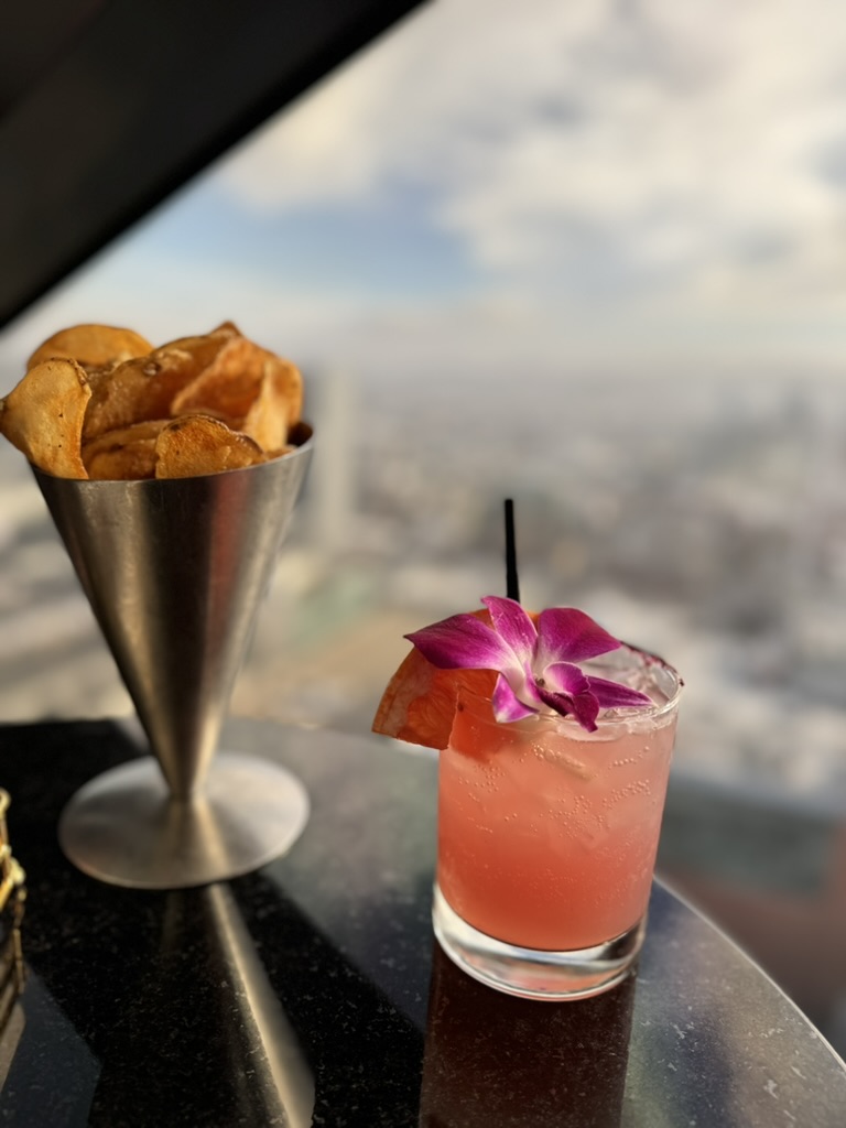 Cocktail with orchid garnish at the View Lounge overlooking San Francisco