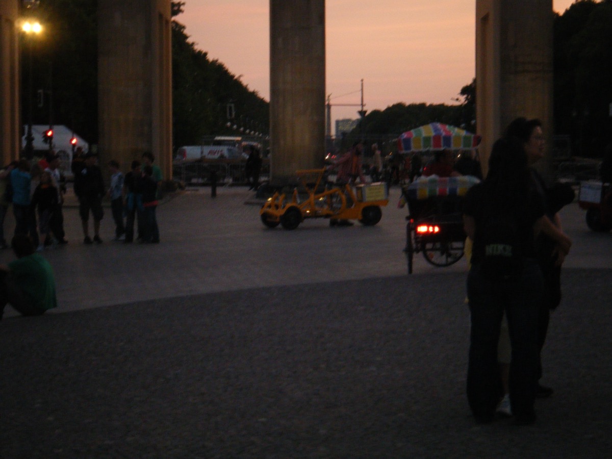 View through Brandenburg Gate columns at sunset