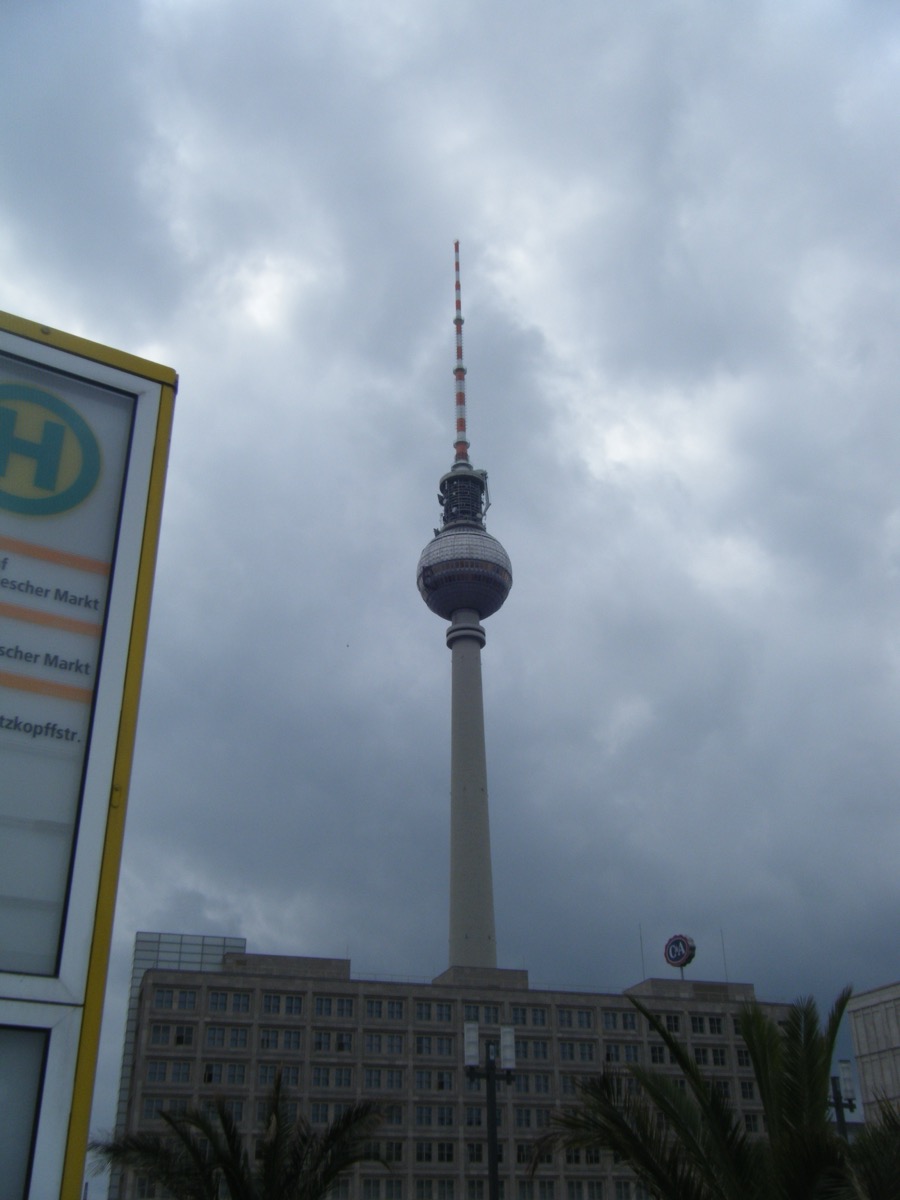 Berlin Fernsehturm TV Tower rising into cloudy sky above Alexanderplatz