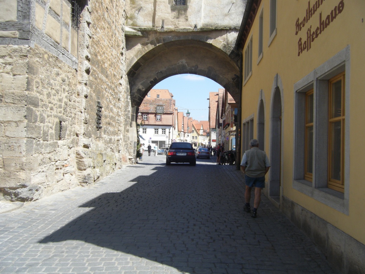 Medieval stone archway in Rothenburg with Kaffeehaus sign