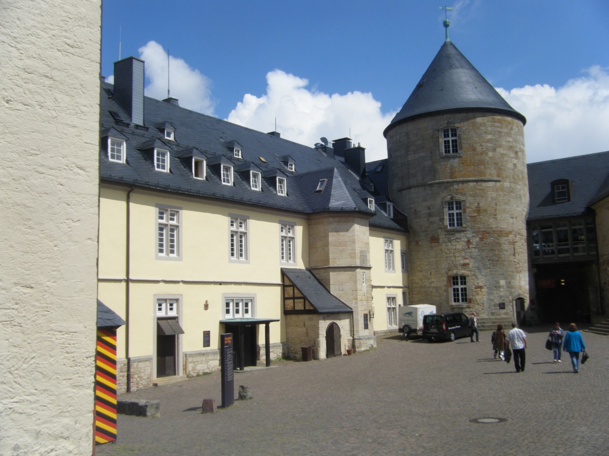 Schloss Waldeck castle courtyard with round stone tower and German flag bunting