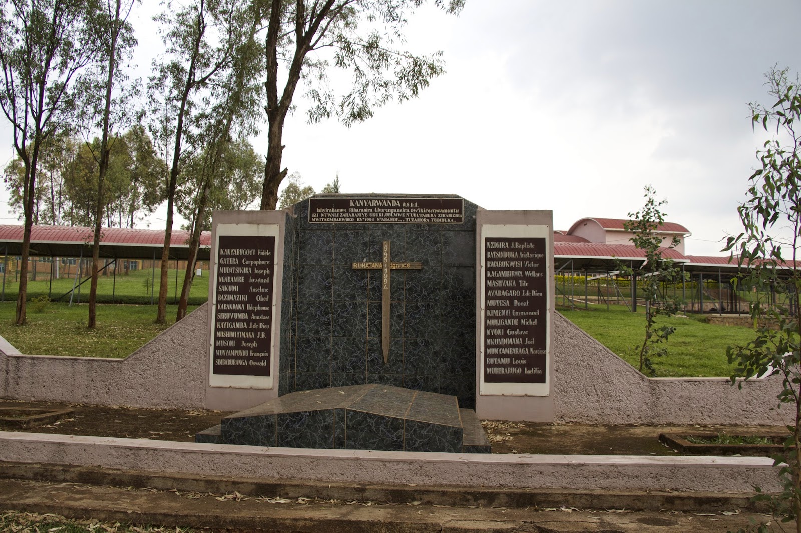 Kanyarwanda genocide memorial monument with a cross and engraved names of victims