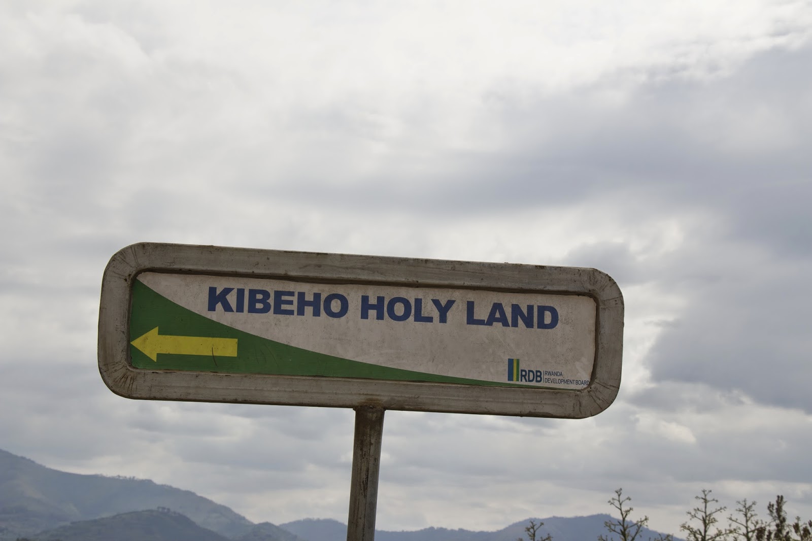 Kibeho Holy Land directional road sign with arrow, posted by the Rwanda Development Board