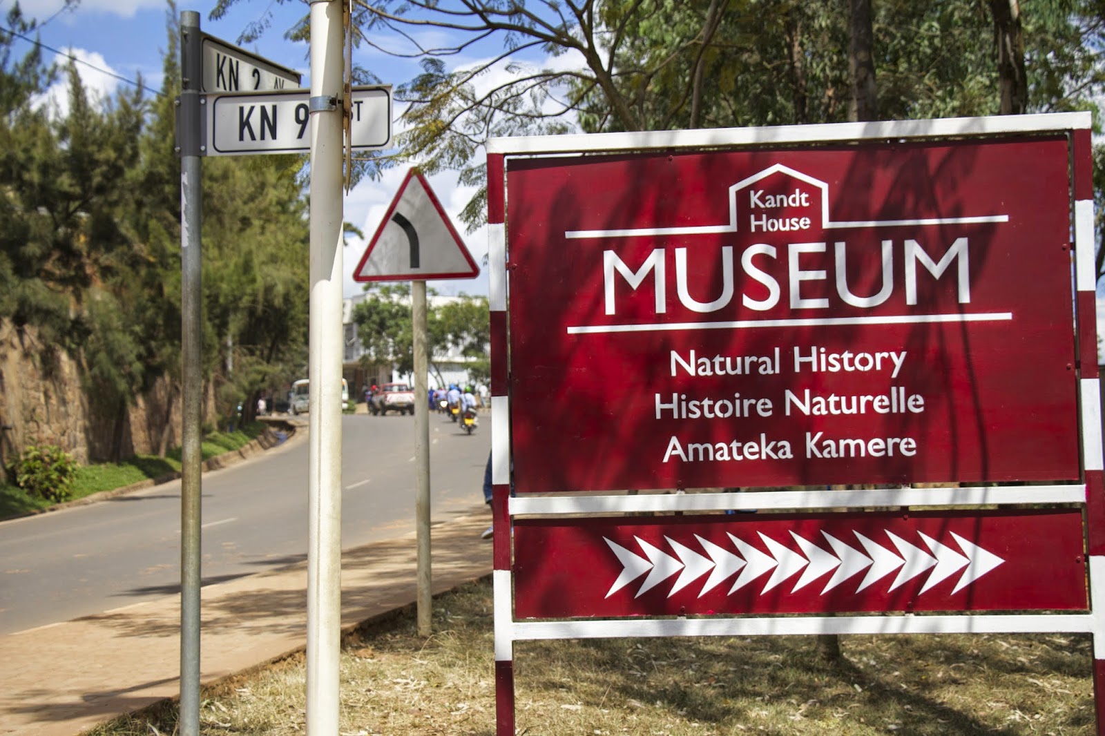 Kandt House Museum sign reading Natural History in English, French, and Kinyarwanda with directional arrows
