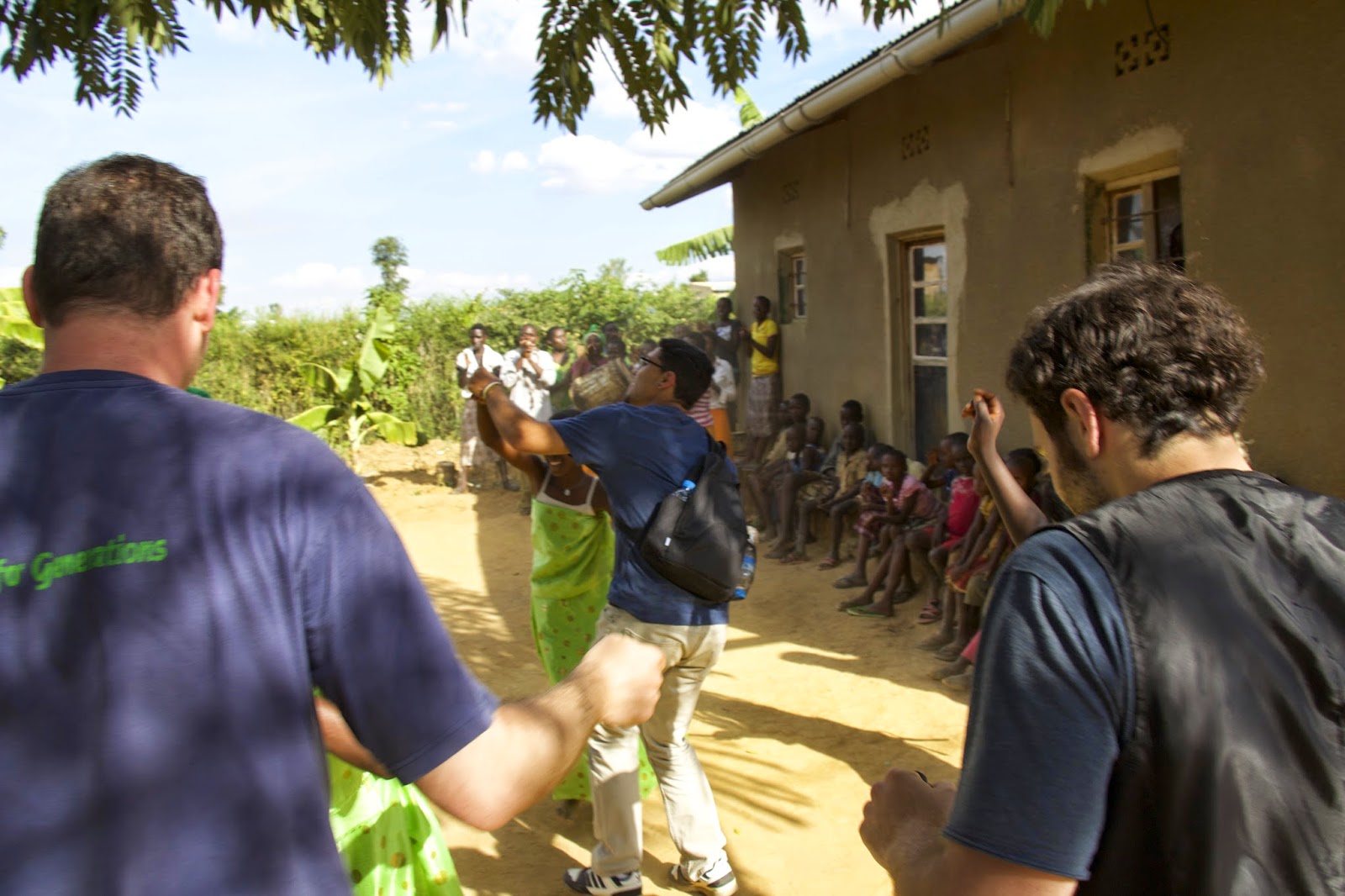 The group joining in a traditional dance at the reconciliation village