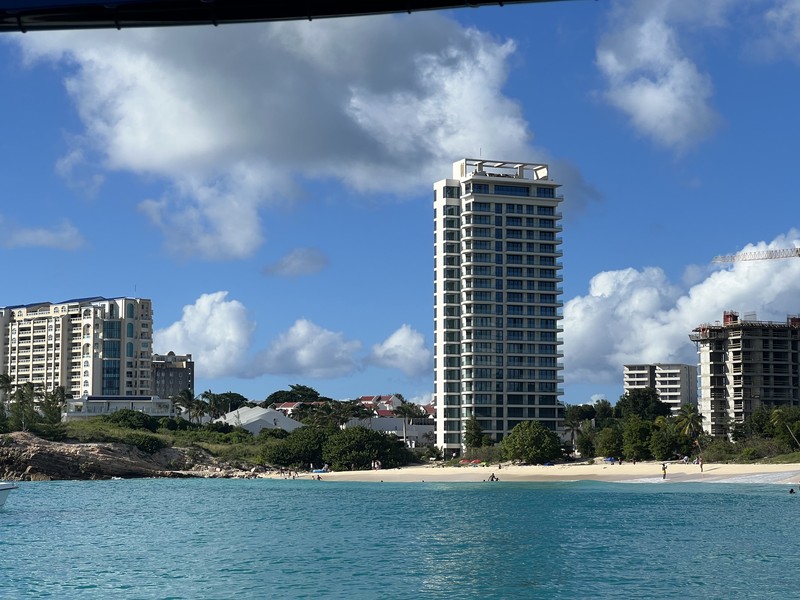 Hotels and beach from the water, high-rise towers along white sand