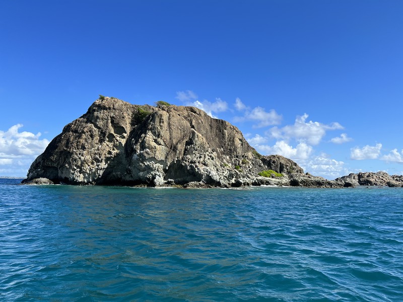 Rocky island outcrop rising from turquoise water