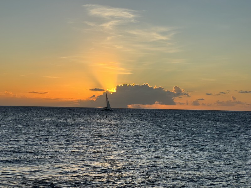 Sailboat silhouette against Caribbean sunset