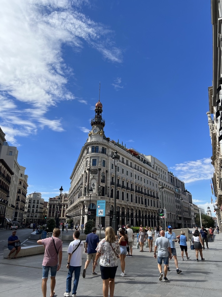 Ornate palace building in Madrid under bright blue sky
