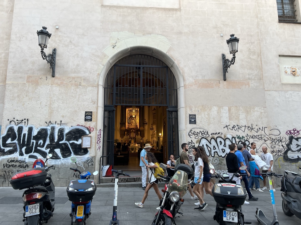 Church facade with colorful graffiti street art on adjacent walls