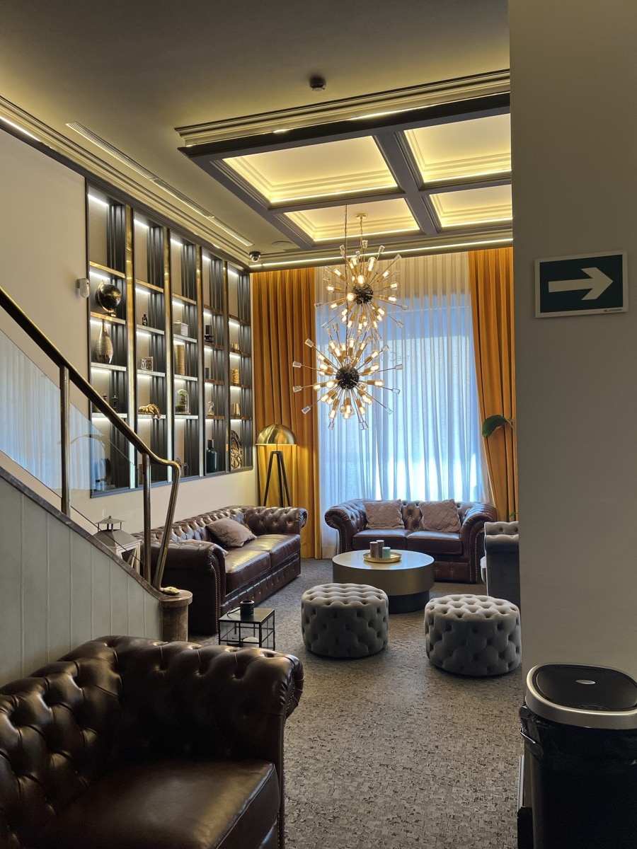 Elegant hotel lobby with leather sofas and sputnik chandeliers