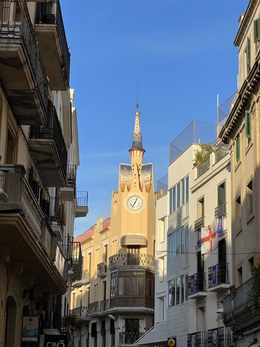 Church tower in Sitges against blue sky