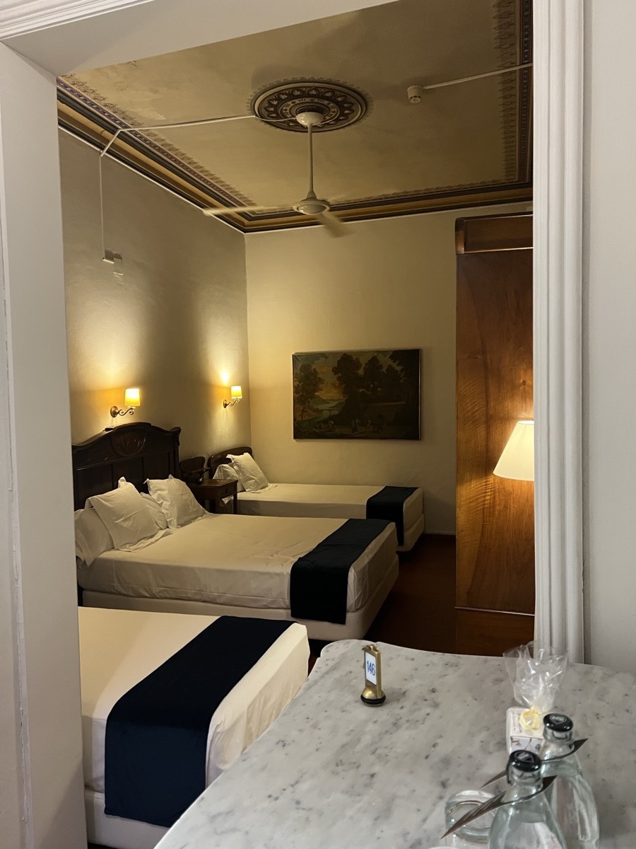 Dim, classically decorated hotel room in Sitges